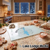 A glass cutting board with a Priest Lake, Idaho design sits on a kitchen counter amidst baking supplies.