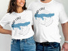 White t-shirts with compass and blue outline of Enid Lake, Mississippi design.