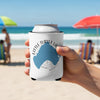 Can cooler with Little Turtle Lake graphic held on a beach.