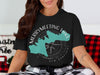 Black t-shirt with Merrymeeting Lake New Hampshire design and compass graphic.