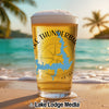 Pint glass with "Lake Thunderbir" and Oklahoma shape on beach background.