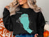 Black sweatshirt with Pyramid Lake, Nevada map and compass graphic.