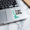 Sticker with turquoise lake shape and "Eagle mountain Life" text on laptop keyboard.