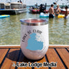 A white stainless steel wine tumbler with Lake St. Clair Michigan text on a wooden boat deck with water and boats in the background.