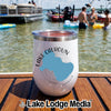 A white stemless tumbler with Lake Calhoun Georgia text and map resting on a wooden boat deck with people swimming.