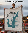Lavon Lake Texas map blanket held by smiling man, with lake background.