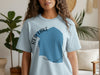 Light blue t-shirt with "