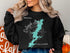 Black sweatshirt with Oologah Lake Oklahoma map and compass graphic.
