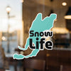 Black text "Snow Life" on a teal, irregularly shaped sticker on a glass surface.