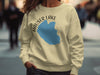 Cream sweatshirt with Hauser Lake Idaho graphic and compass rose design.