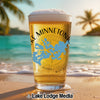 Glass of beer with Lake Minnetonka map logo on a beach at sunset