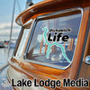 Window decal with "Pickwick Life" and a turquoise lake outline on a wooden boat.