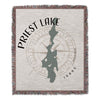 Priest Lake Idaho map on a woven blanket with compass rose and fringed edges.