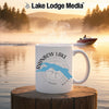 White mug with "Rainbow Lake Maine" text and compass design on a foggy lake background.