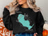 Black sweatshirt with blue Sandhill Lake, Wisconsin graphic and compass.