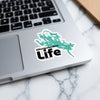 Winnipesaukee Life sticker with lake outline on a laptop keyboard