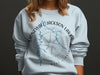Light blue sweatshirt with Stonewall Jackson Lake, West Virginia map and compass design.