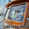 Summersville Life logo on a boat window, with Lake Lodge Media text.