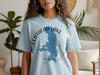 Light blue shirt with "Flathead Lake Montana" and a compass graphic.