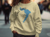 Light yellow sweatshirt with a blue Lake Waco map and compass graphic.