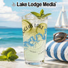 Glass with Douglas Lake map graphic and mint garnish, with beach background.