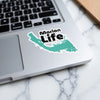 Sticker with "Marion Life" text and a turquoise map outline on a laptop.