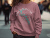Pink sweatshirt with Lake Tuscaloosa, Alabama map and compass graphic.
