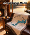 Lake Wallenpaupack Pennsylvania map blanket on brown leather sofa by fireplace.