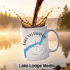 White mug with "Lake Ullswater England" design, coffee pouring into it.