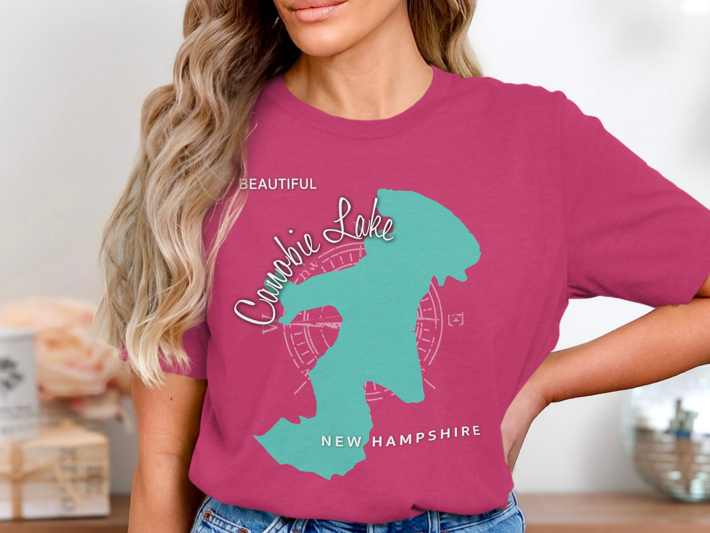 Teal compass design on pink t-shirt with "Beautiful Candie Lake New Hampshire" text.
