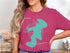 Teal compass design on pink t-shirt with "Beautiful Candie Lake New Hampshire" text.