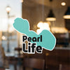 Turquoise sticker with black text "Pearl Life" on a window.