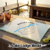 A glass cutting board featuring a map of Banks Lake, Washington, on a wooden outdoor bar.