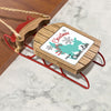 Wooden sled ornament with "Merry Christmas FROM Shaver Lake" text and snowflakes.