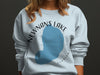 Light blue sweatshirt with Newnans Lake Florida graphic and compass rose.