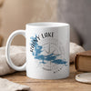 White mug with Rainy Lake Minnesota text, trees, and compass design.