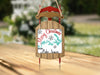 Sled ornament with "Merry Christmas FROM Lake James" text and snowflakes.