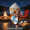 Iced coffee with whipped cream, s'mores ingredients, fire pit, lake, and chairs at night.