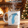 White mug with "Lake Michigan" and compass design, steaming coffee splashing.
