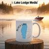 White mug with "Black Lake Idaho" graphic and compass rose on a lakeside background.