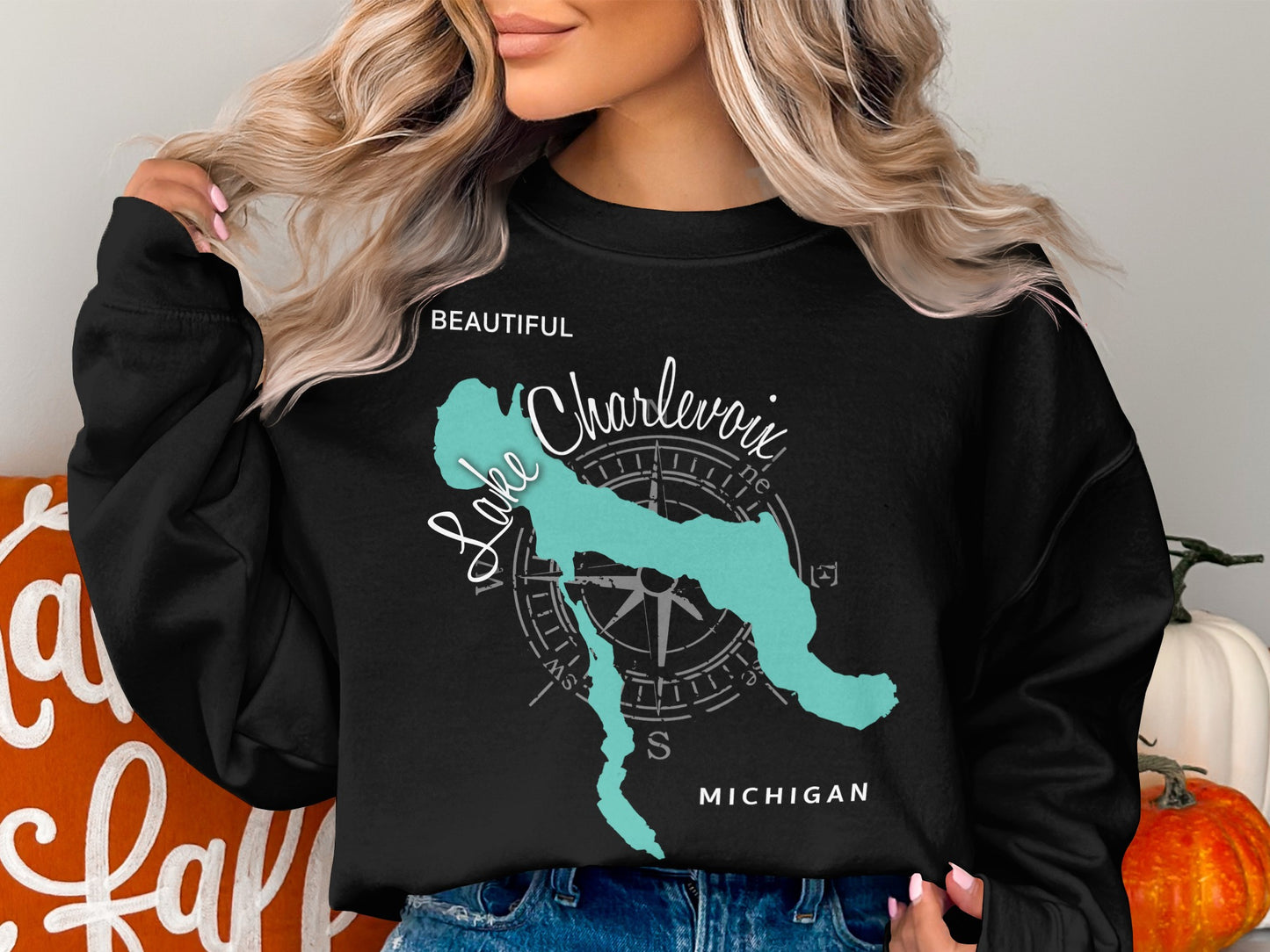 Black sweatshirt with a blue outline map of Lake Charlevoix and compass rose.