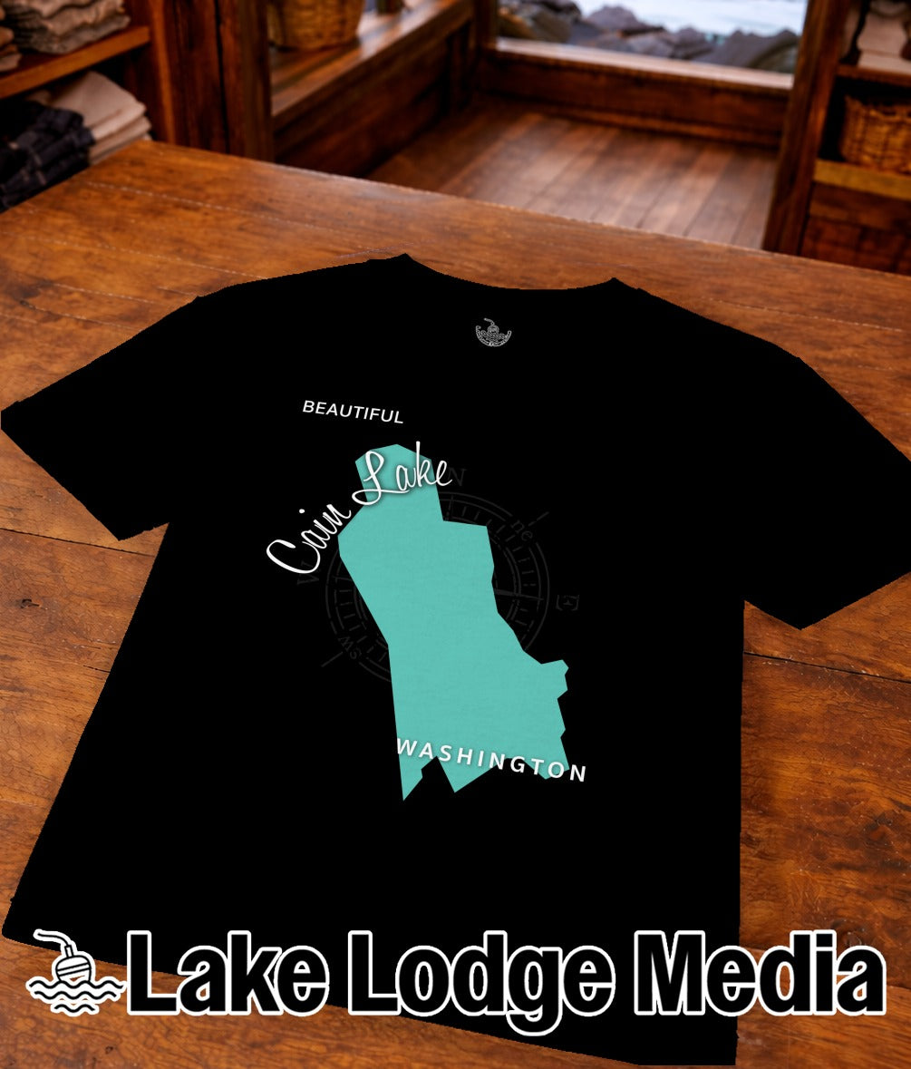 Black t-shirt with a teal outline map of Lake Cougar, Washington, and "Lake Lodge Media" text.