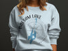 Light blue sweatshirt with Balsam Lake Ontario graphic and compass rose.