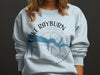 Light blue sweatshirt with Lake Rayburn Arkansas compass graphic and blue lake outline.