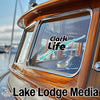 Sticker with "Clark Lake Life" text and a teal outline of a lake on a boat window.