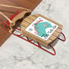 Wooden sled ornament with "Merry Christmas FROM Little Turtle Lake" text.
