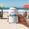 White can cooler with Enid Lake map and compass design, held on beach.