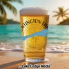 Glass of beer with Huntington Lakes logo and California outline on a beach.