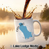 White mug with "Cain Lake Washington" map and compass design, coffee pouring in.