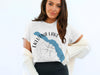 White t-shirt with Eklutna Lake Alaska map and compass graphic with text.